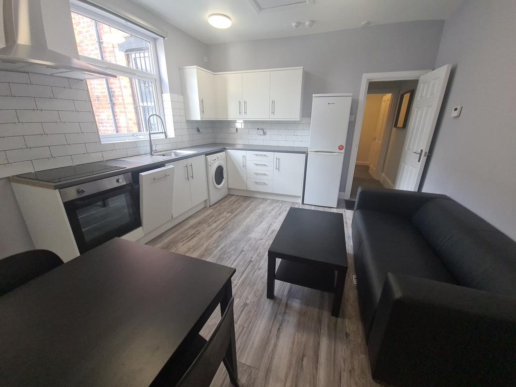 Bright fitted kitchen with seating and applianc...