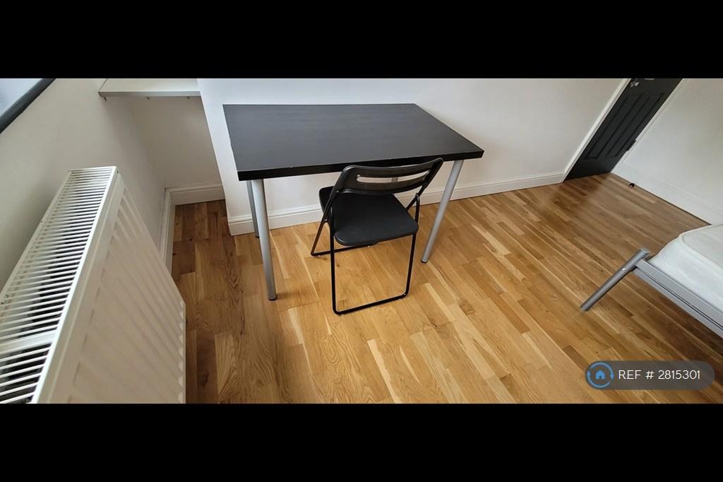 A Desk With a Chair And Built-In Book Shelves