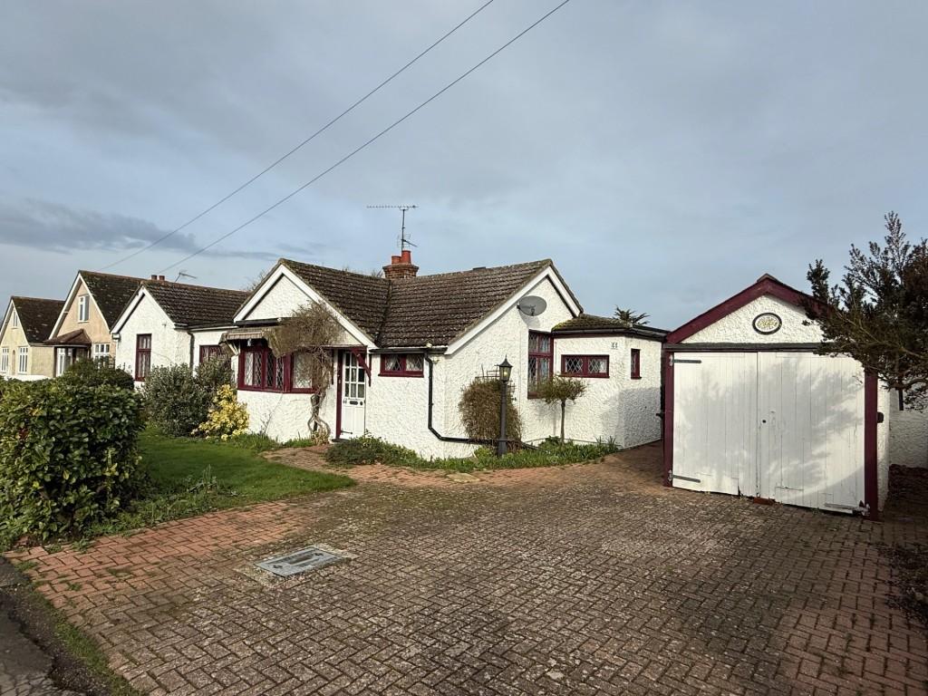Front of the detached bungalow with garage and par