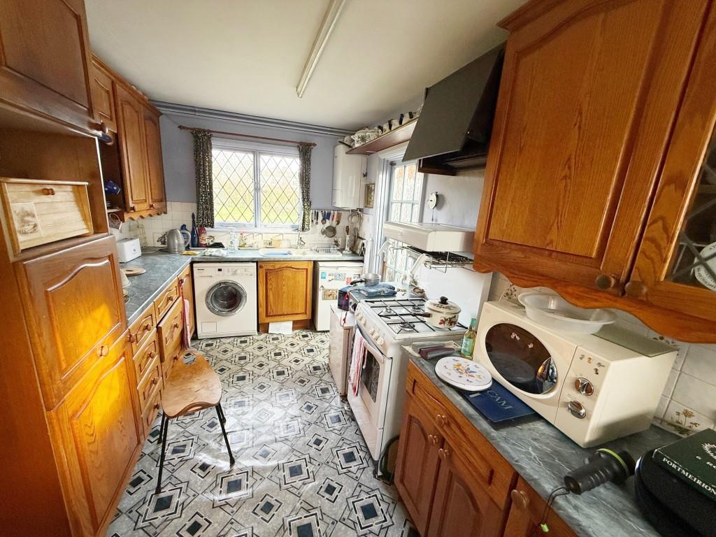 Kitchen with window to rear and side door
