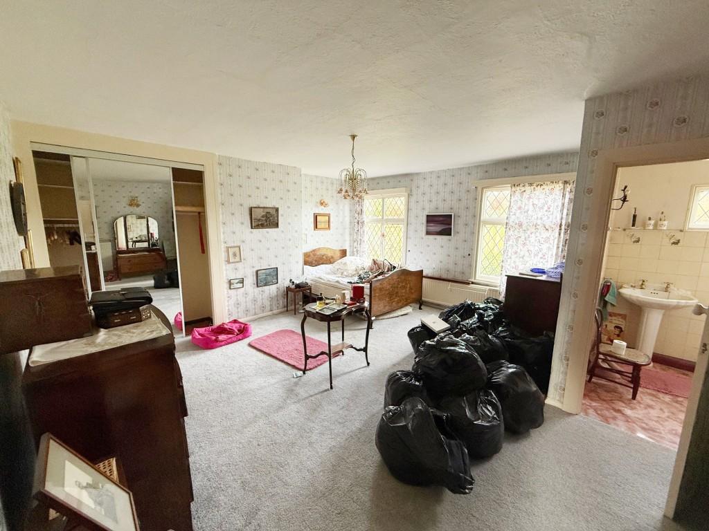 Bedroom one with cupboards and en-suite