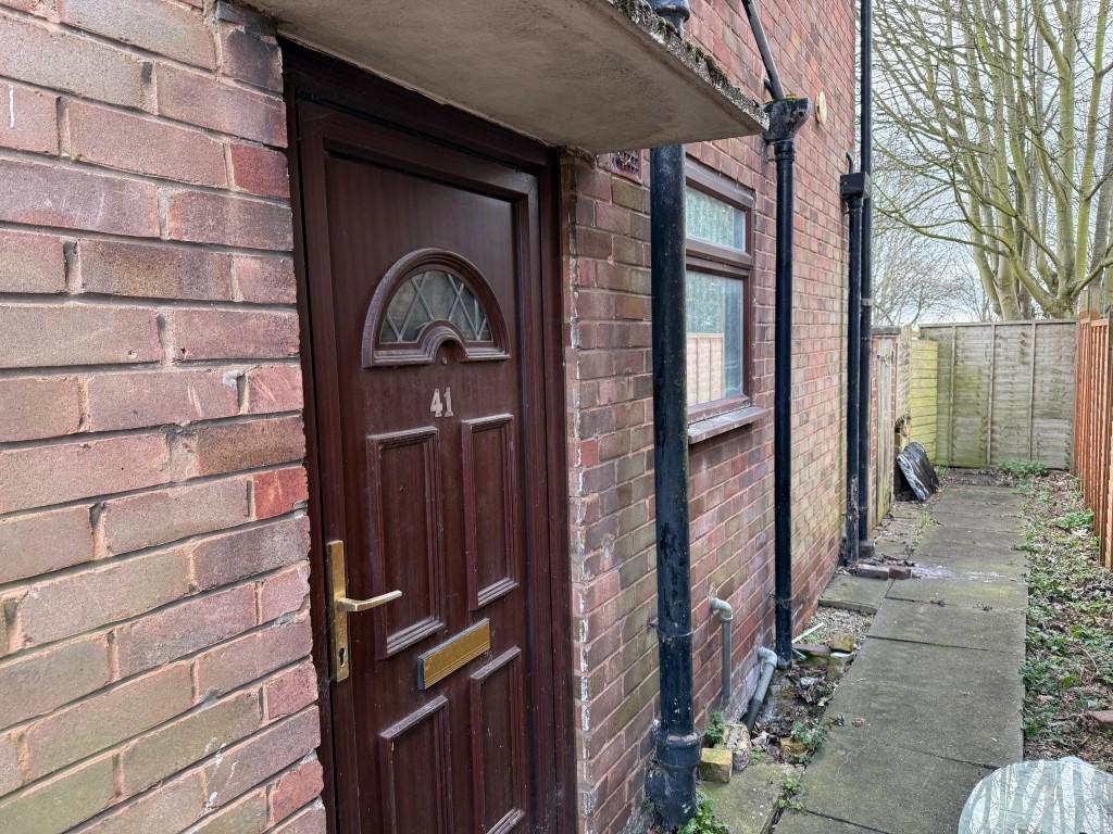 Entrance door to the side of the property