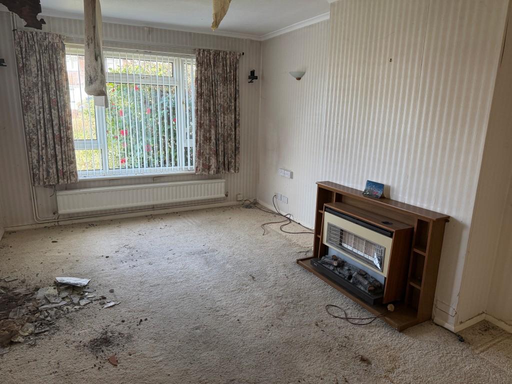 Living room with gas fire and window to front