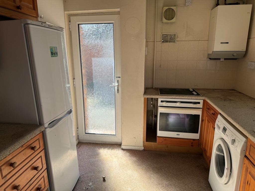 Kitchen with window and glazed door to side access