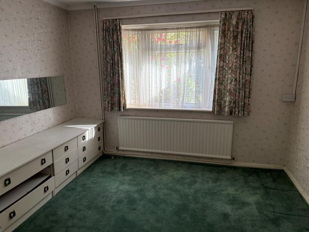 Main bedroom with window to rear