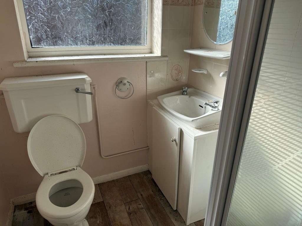 Shower room with white suite and window to rear