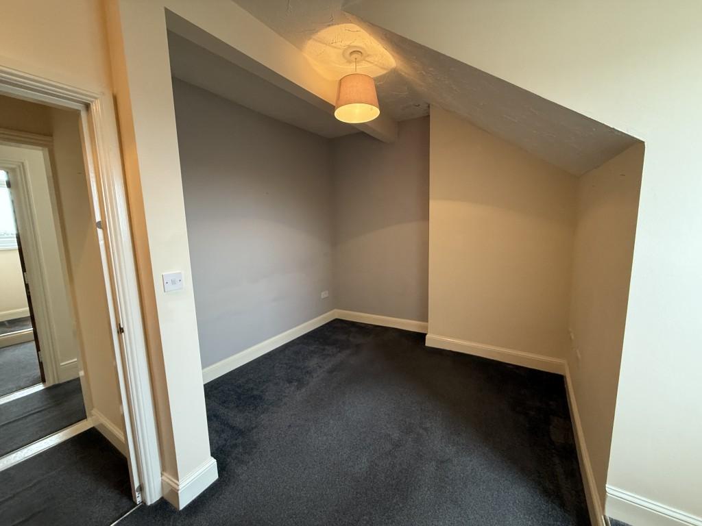 Bedroom with neutral colours and grey carpet