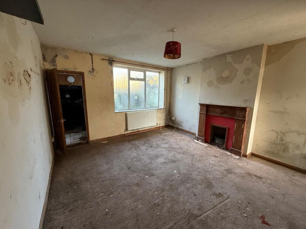 Ground floor lounge with window and doors leading