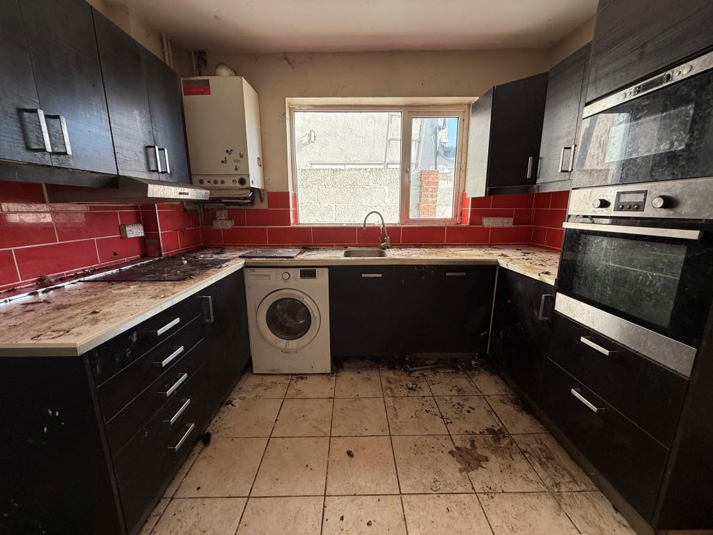 Kitchen showing appliances with window and boiler