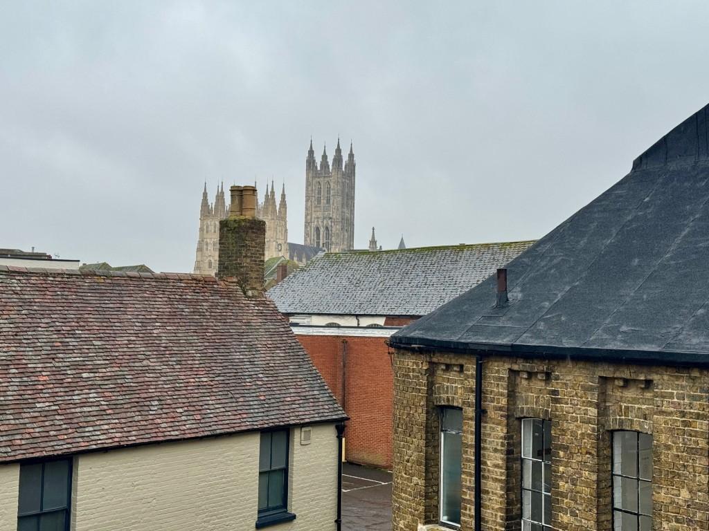 View from top floor window over rooftops towards C