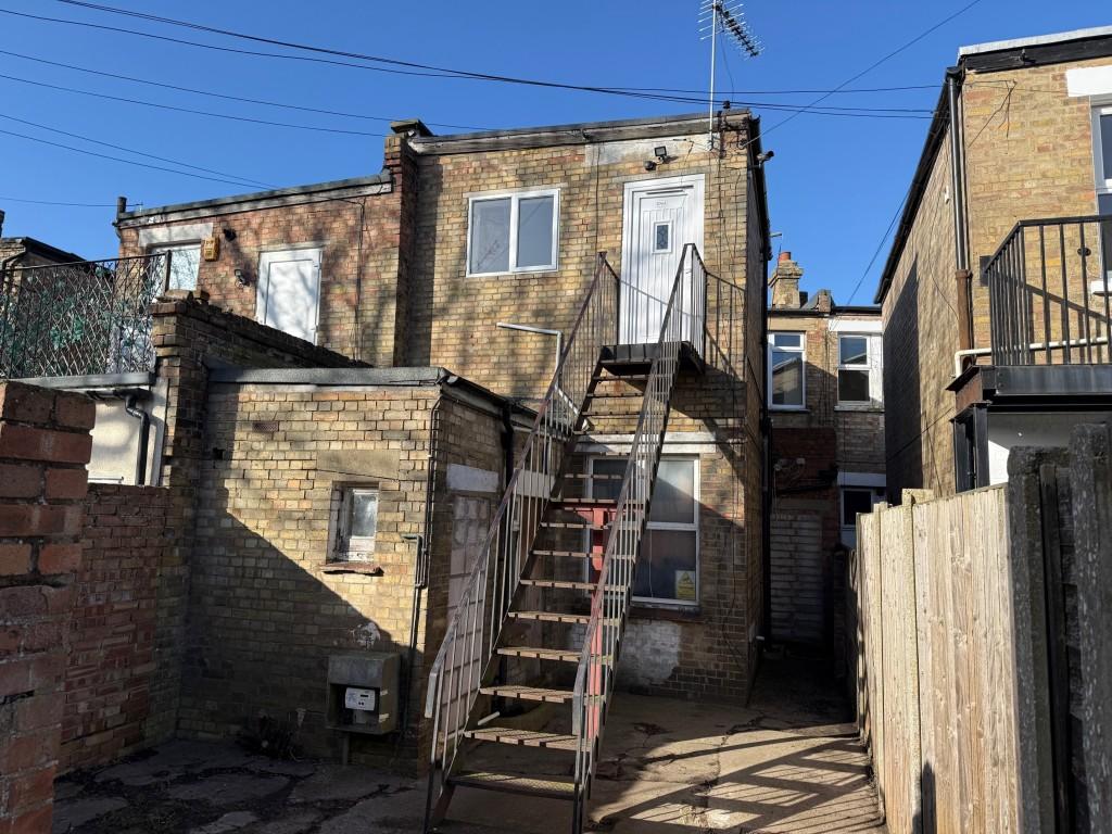 Yard and entrance to the flat at the rear of the b