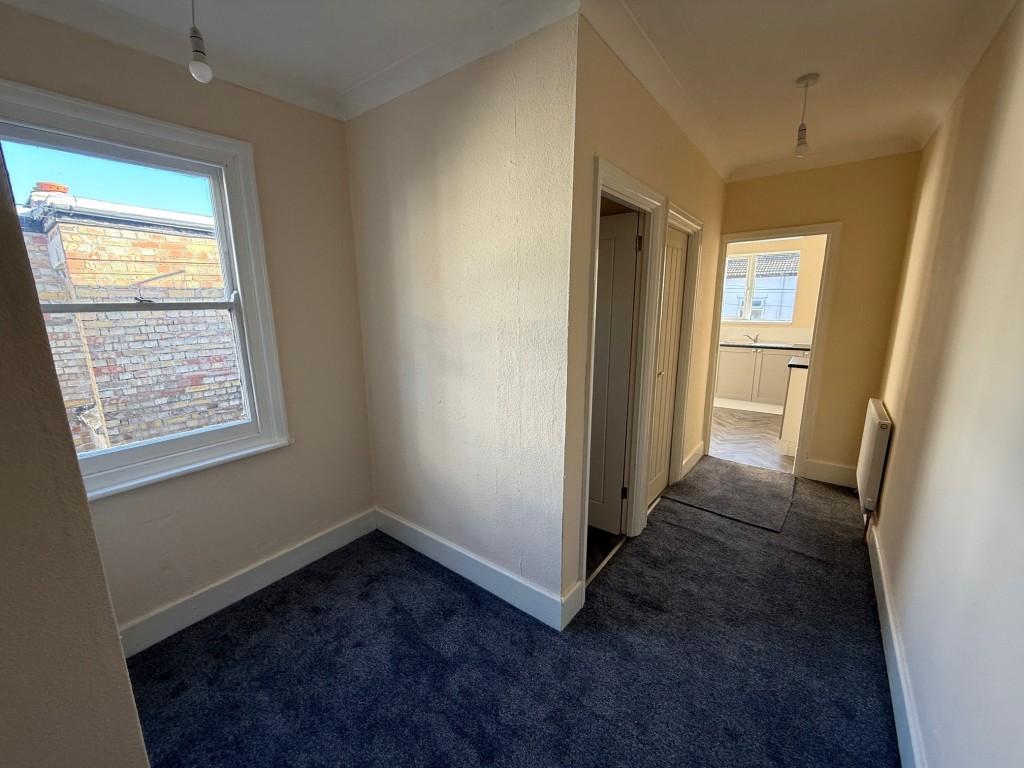Hallway with window to side and boiler cupboard