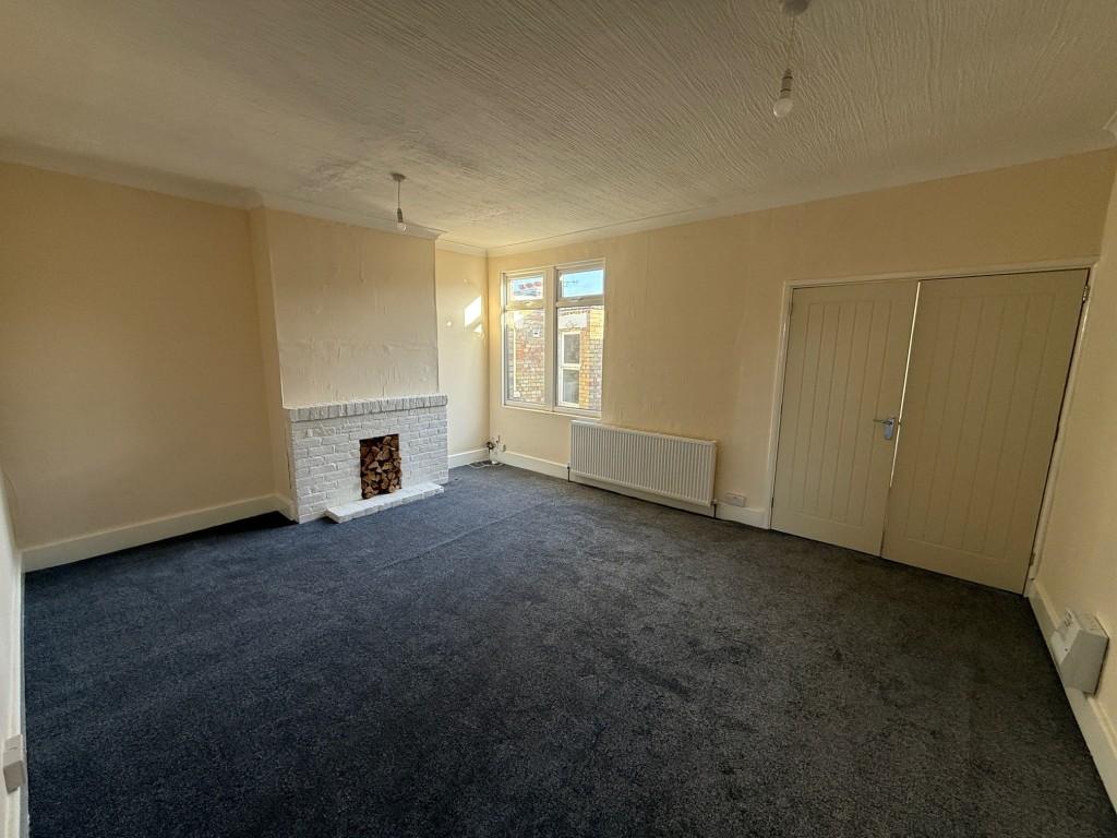 Living room with fireplace and widow to rear