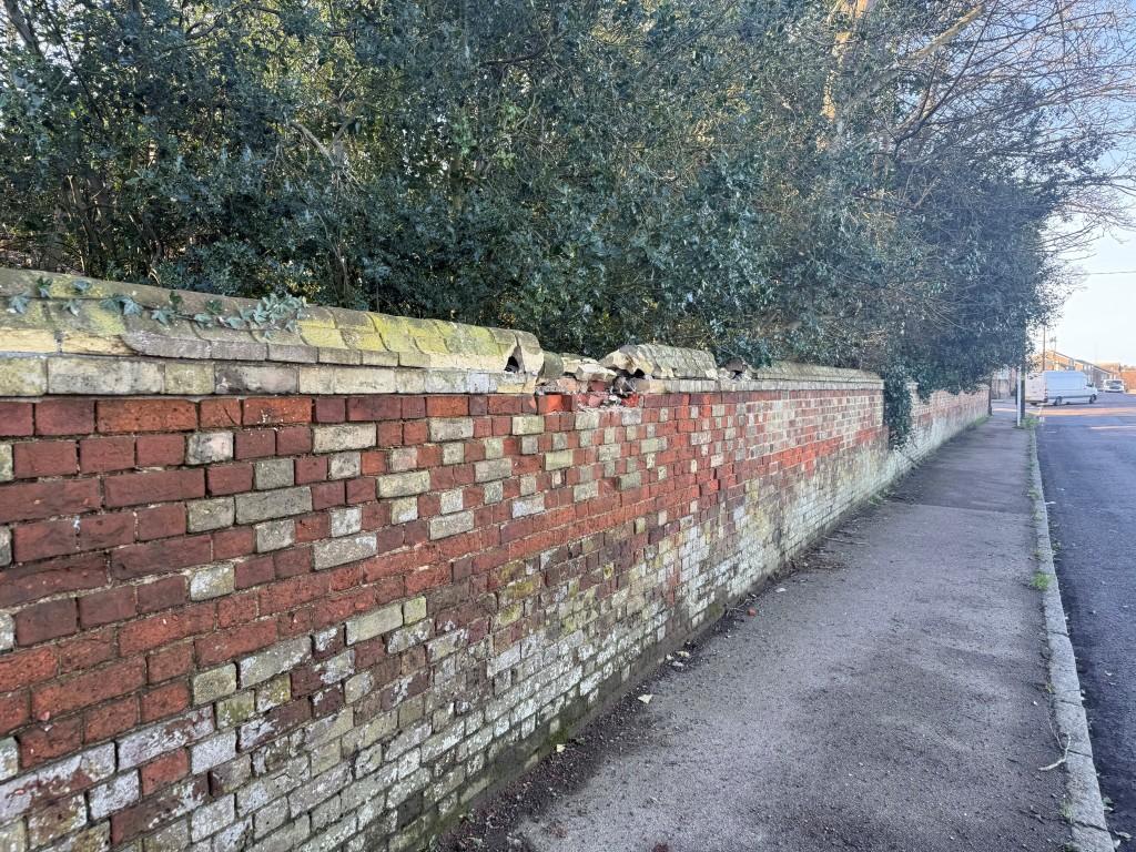 Shot showing damage to brick of wall