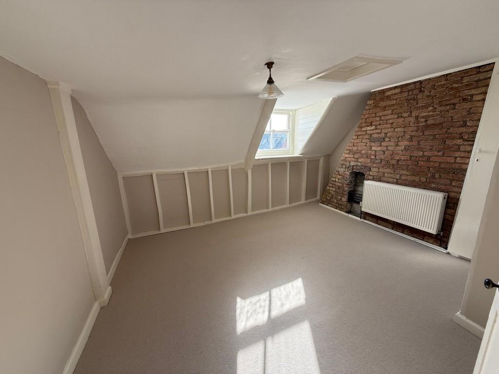 Bedroom with exposed brick chimney breast