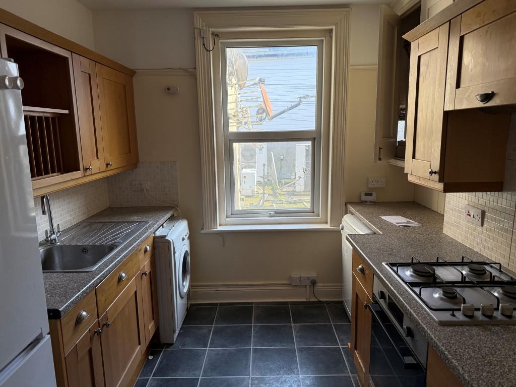 Kitchen with window and fitted units