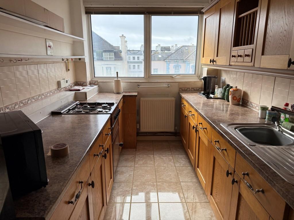 Kitchen with fitted units and window