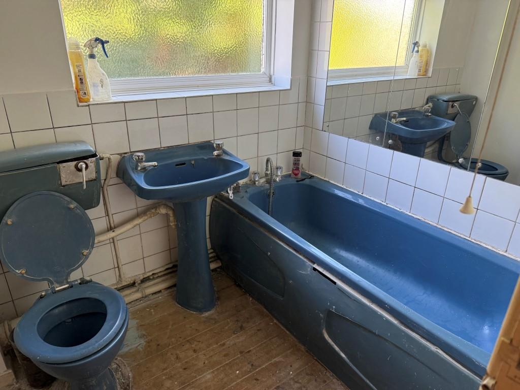 Blue bathroom suite with sink and WC