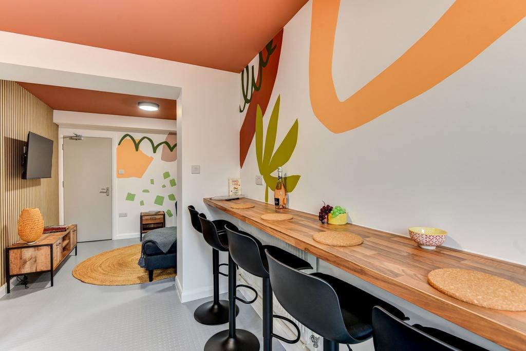 Bright, modern communal workspace with a long w...