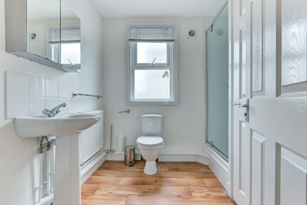 Bright, well-maintained bathroom with white fix...