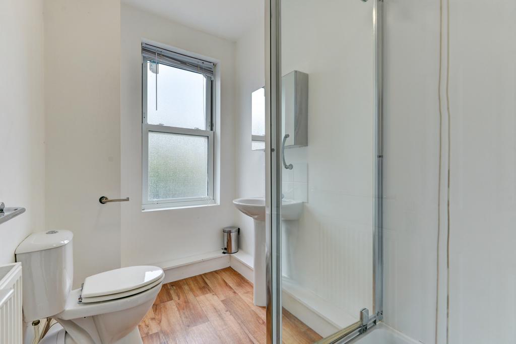 Bright, well-kept bathroom featuring a shower c...