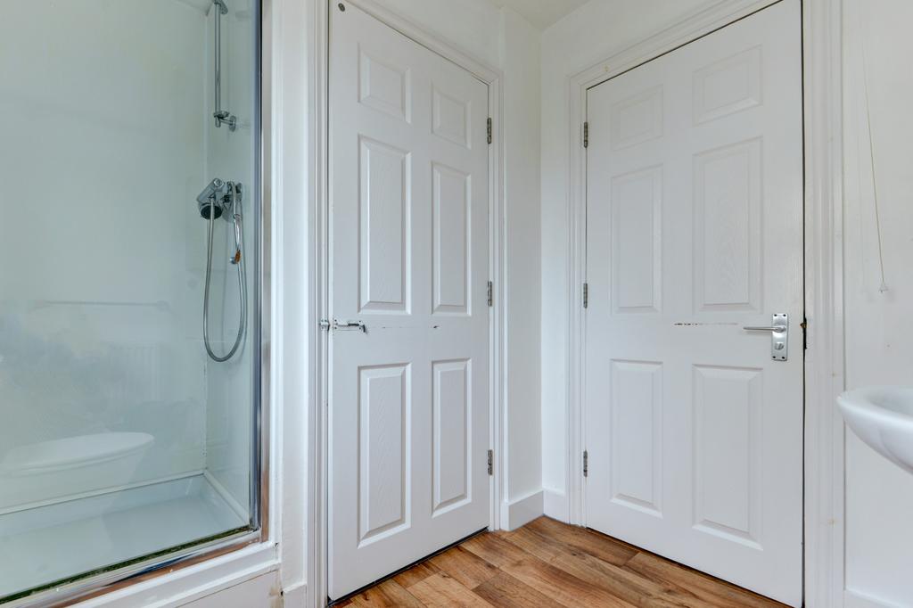 A modern bathroom suite featuring a spacious sh...