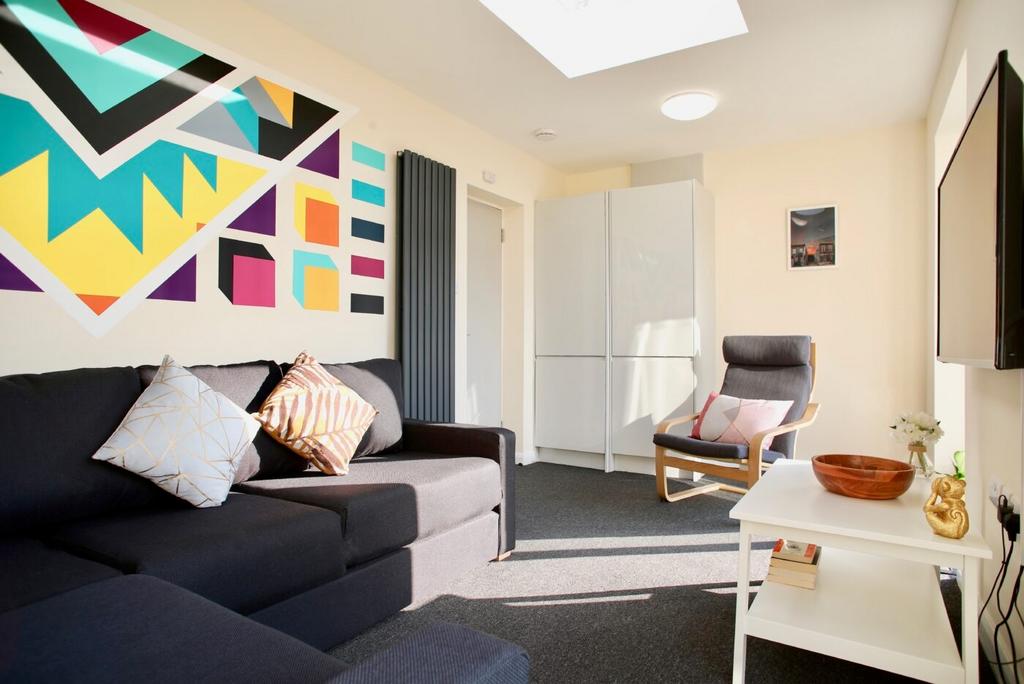 Bright, modern living room with a comfortable d...