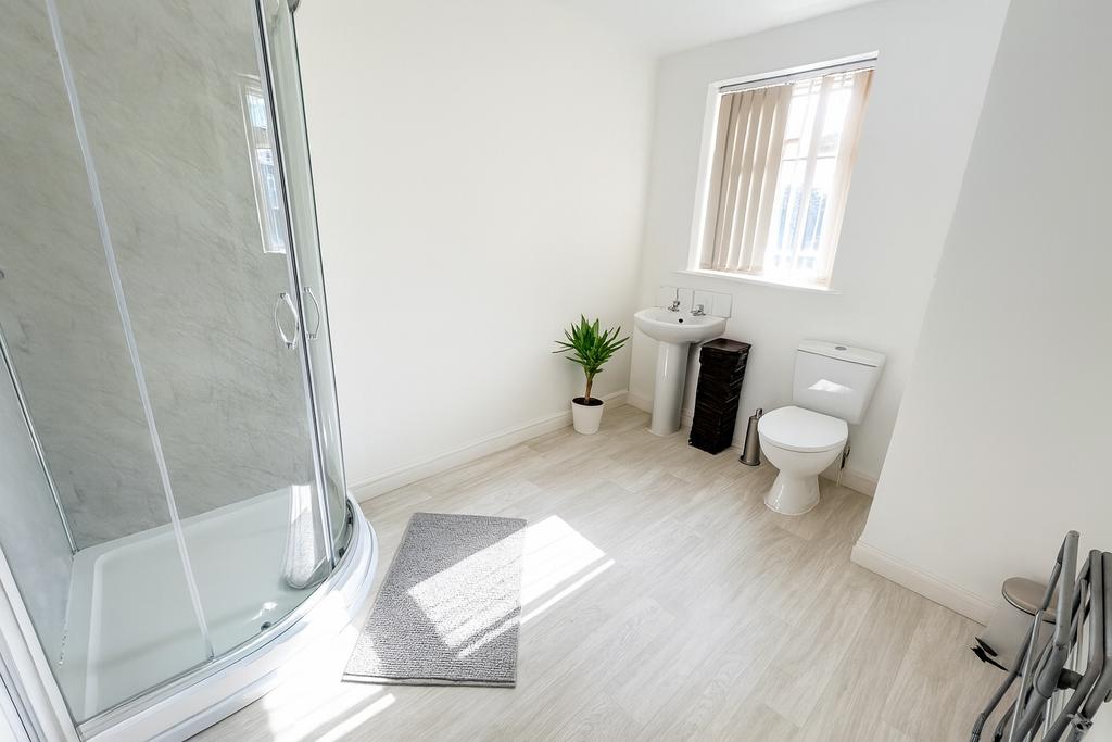 Bright and clean bathroom with a corner shower ...