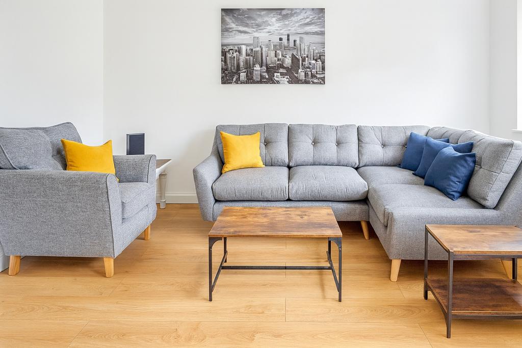 Bright, modern living room with a light grey se...