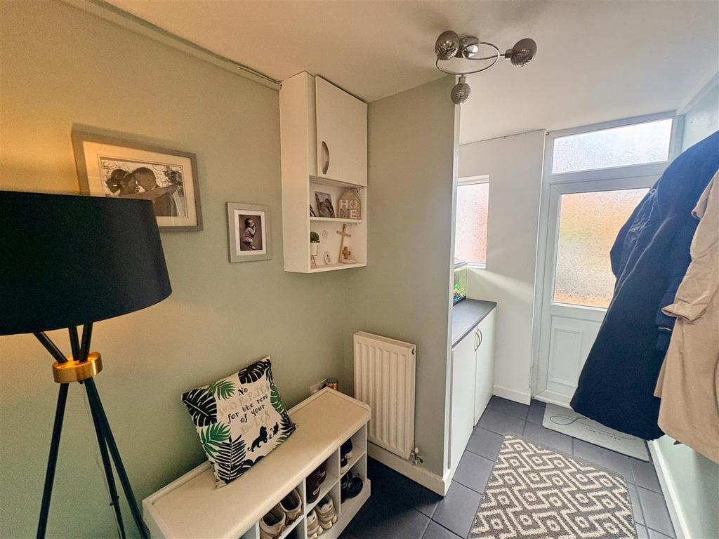 Through entrance hall with utility area
