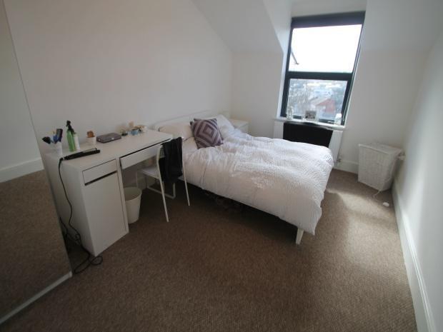 Bright single bedroom with bed and desk...