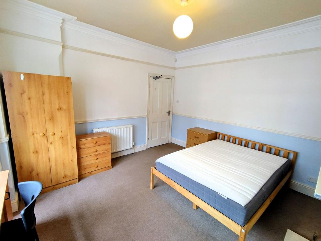 Bright double room with bed and storage...
