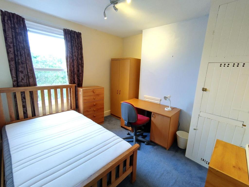 Bright room with bed, desk and wardrobe...