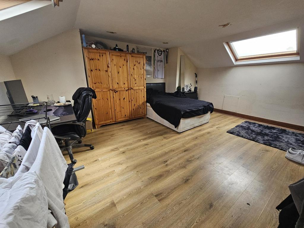 Bright, spacious attic bedroom with skylights...