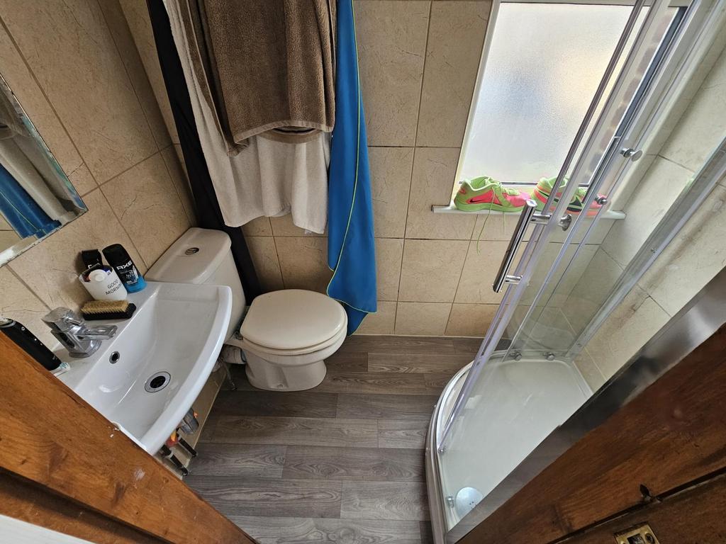 Modern ensuite with shower and fitted storage...