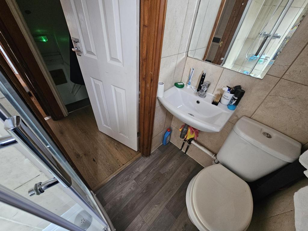 Compact bathroom with shower and basin...