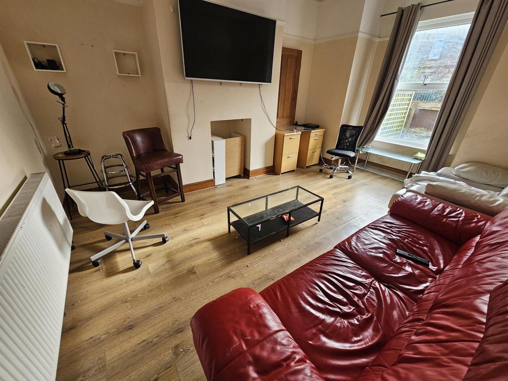 Bright living room with large window and seatin...