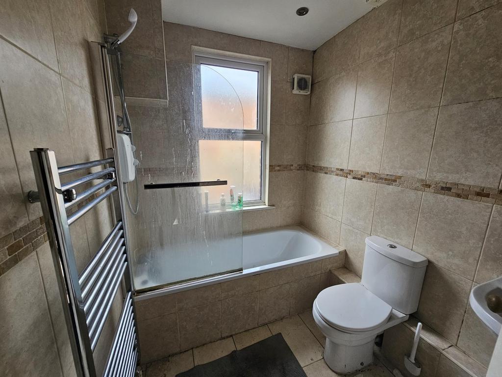Modern tiled bathroom with bath and heated rail...