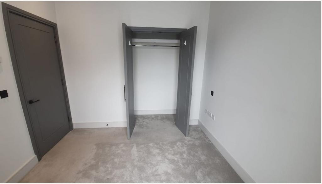 Bedroom with built-in wardrobe and private balcony