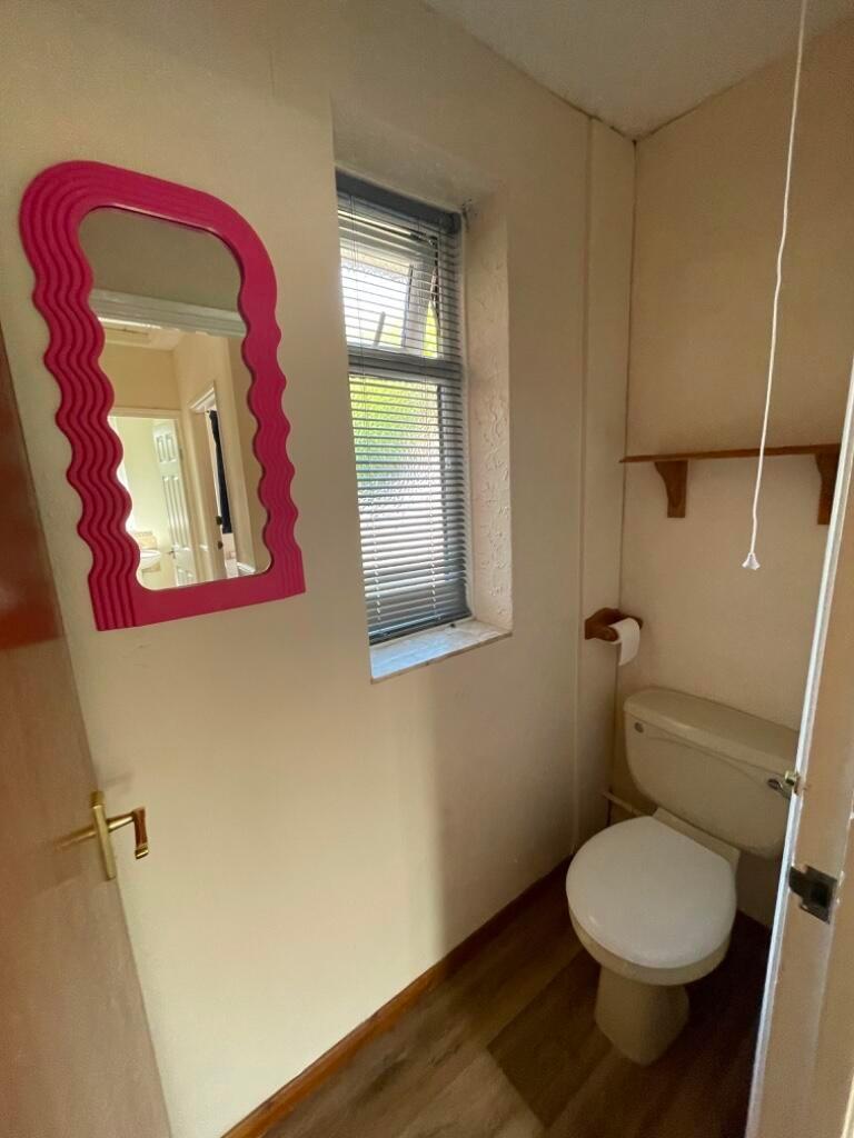 Compact WC with a window for natural light, sim...