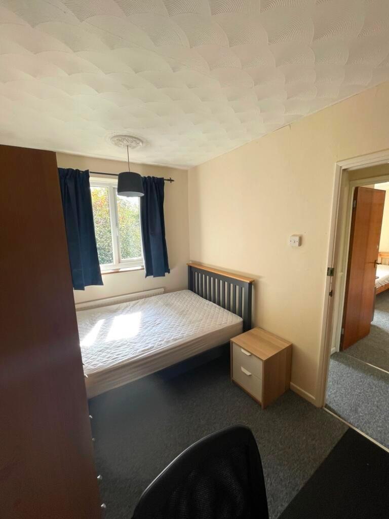 Bright double bedroom with a comfortable bed, b...