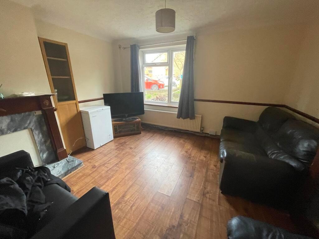 Bright ground-floor living room with large fron...