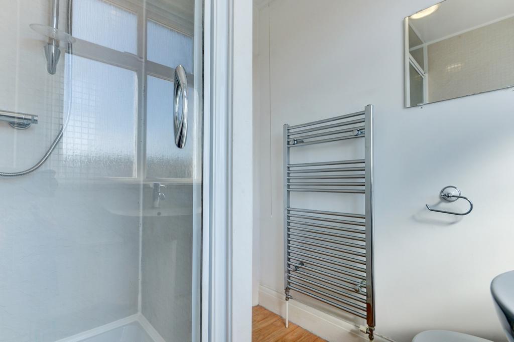 Bright, modern bathroom with a walk-in shower, ...