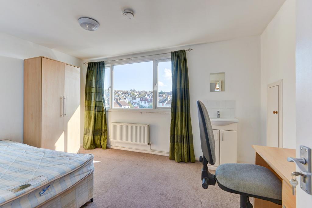 Bright and welcoming bedroom with a large windo...