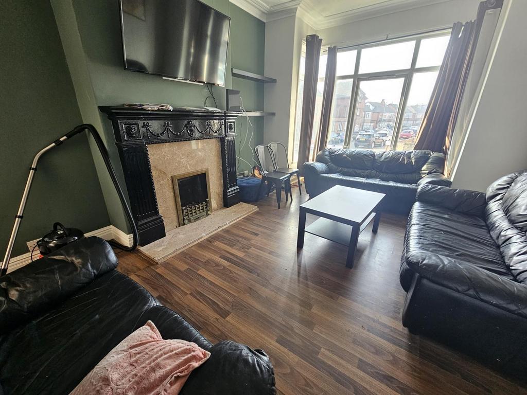 Bright lounge with bay window and fireplace...