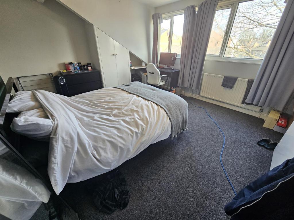 Bright bedroom with large window and storage...