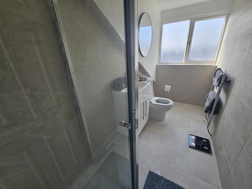 Bright modern bathroom with walk-in shower...