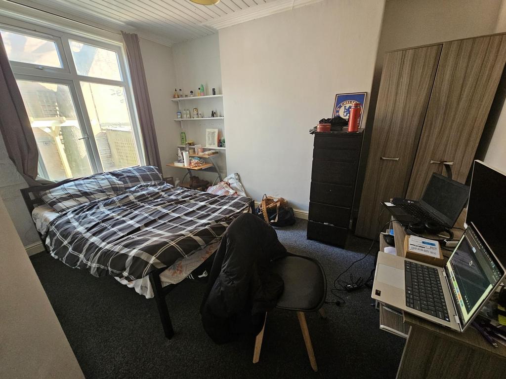 Bright bedroom with desk and storage...