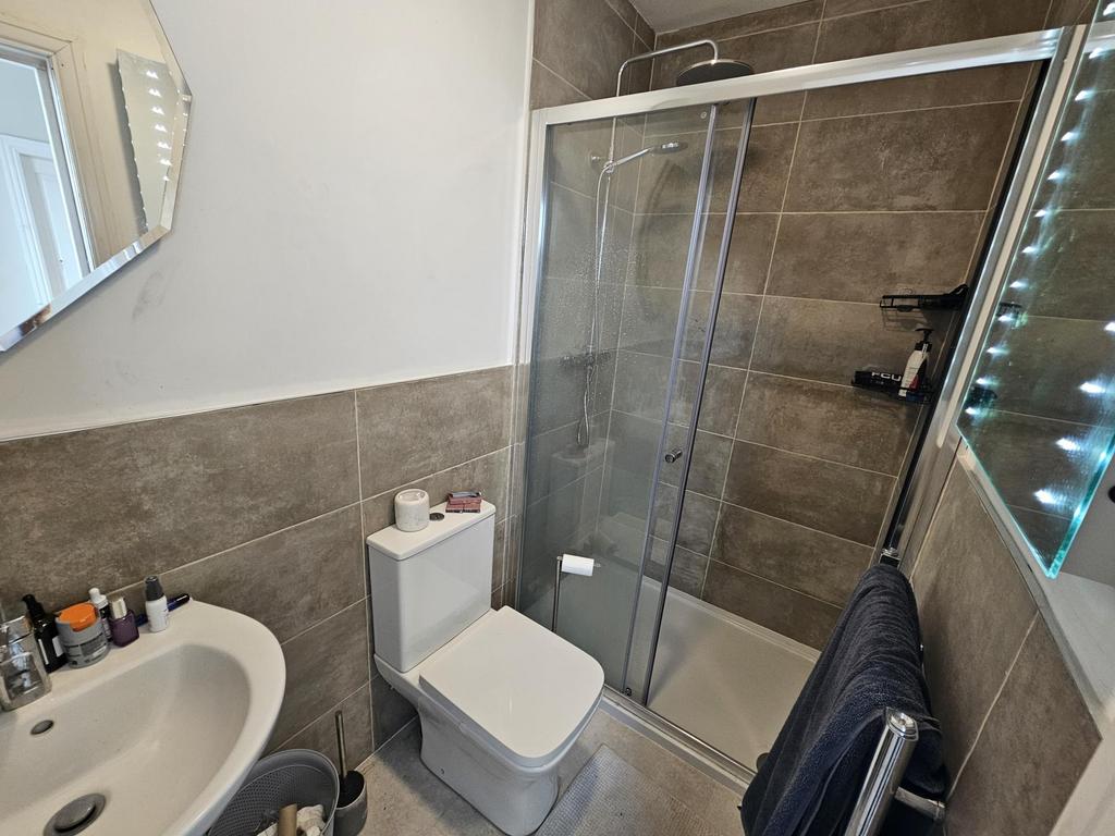 Modern tiled bathroom with glass shower...