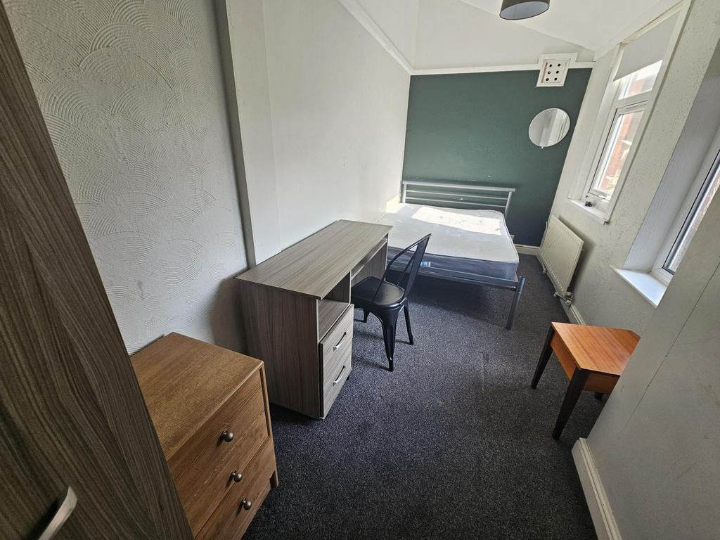Bright bedroom with bed, desk and wardrobe...